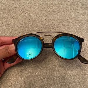 Gently used ray bans - blue/teal lens round, with gold bar and tortoise frame.